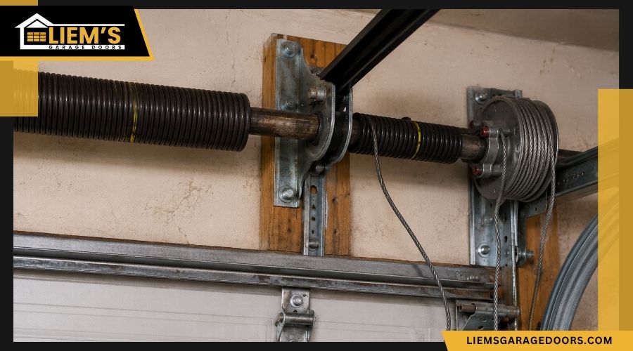 Broken garage door spring with a loose cable
